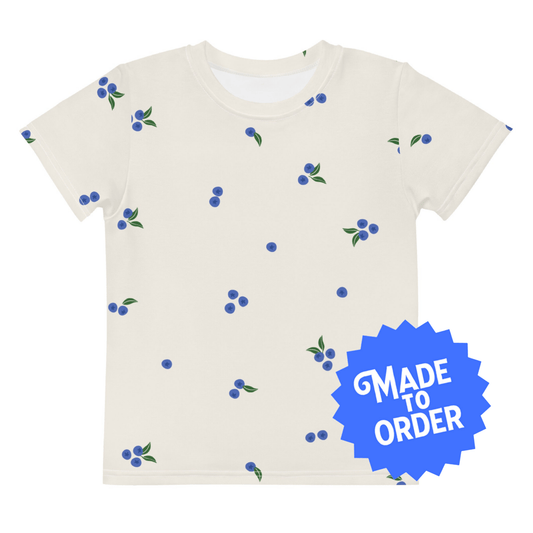 Chunky Deli product image: Kids' and toddler t-shirt with an all-over print of blueberries scattered on the front and back. The t-shirt has short sleeves, a crew neck collar, and a unisex cut.