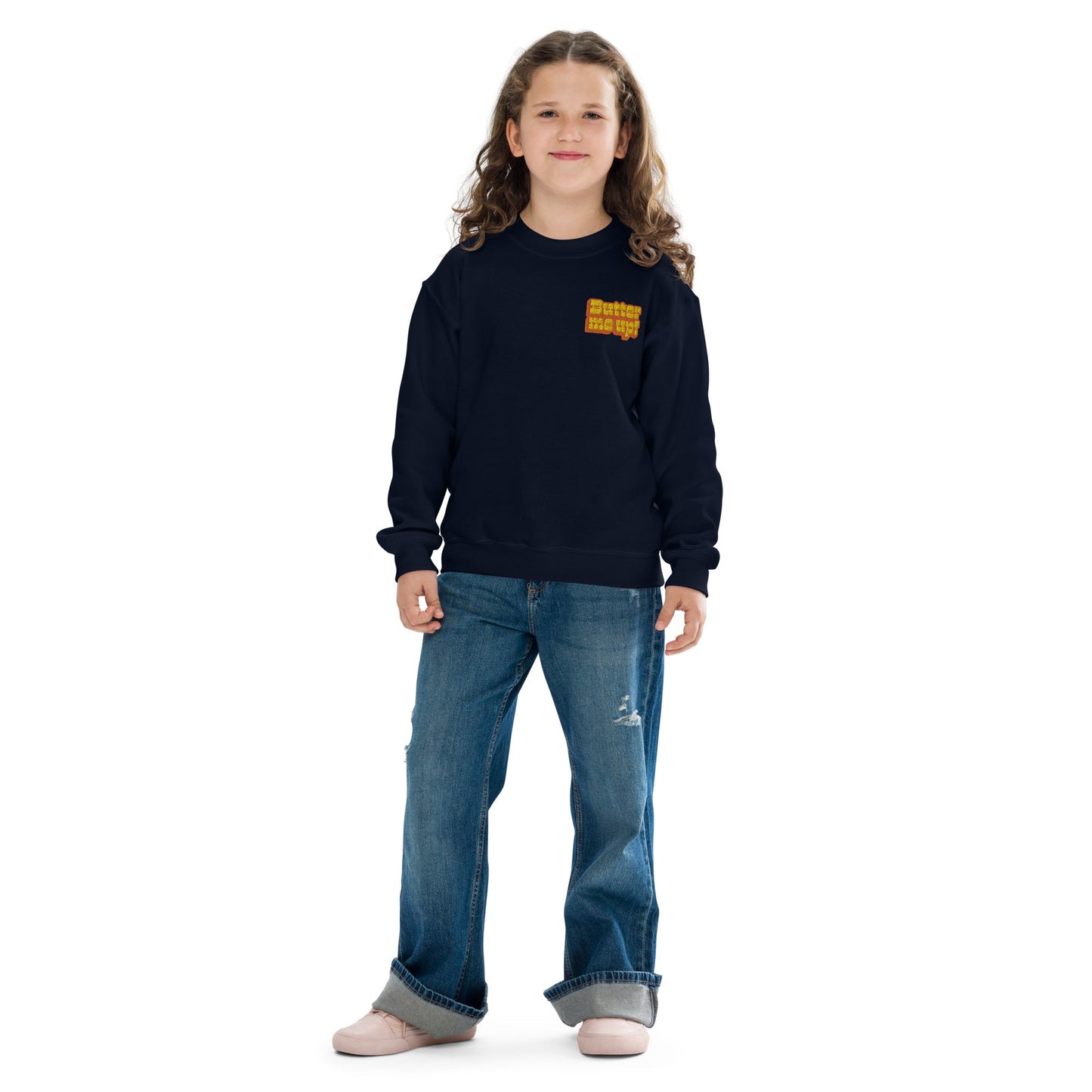 Chunky Deli product image: Girl wearing a black "Butter Me Up" sweatshirt with the text "Butter Me Up" printed in orange and red across the chest. She is wearing jeans and standing in front of a white background.