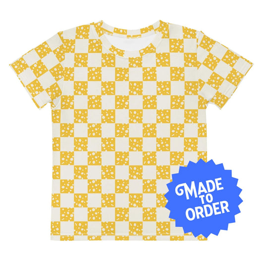 Chunky Deli product image: Kids' and toddler t-shirt with an all-over check mark pattern of yellow cheese illustrations on the front and back. The t-shirt has short sleeves, a crew neck collar, and a unisex cut.