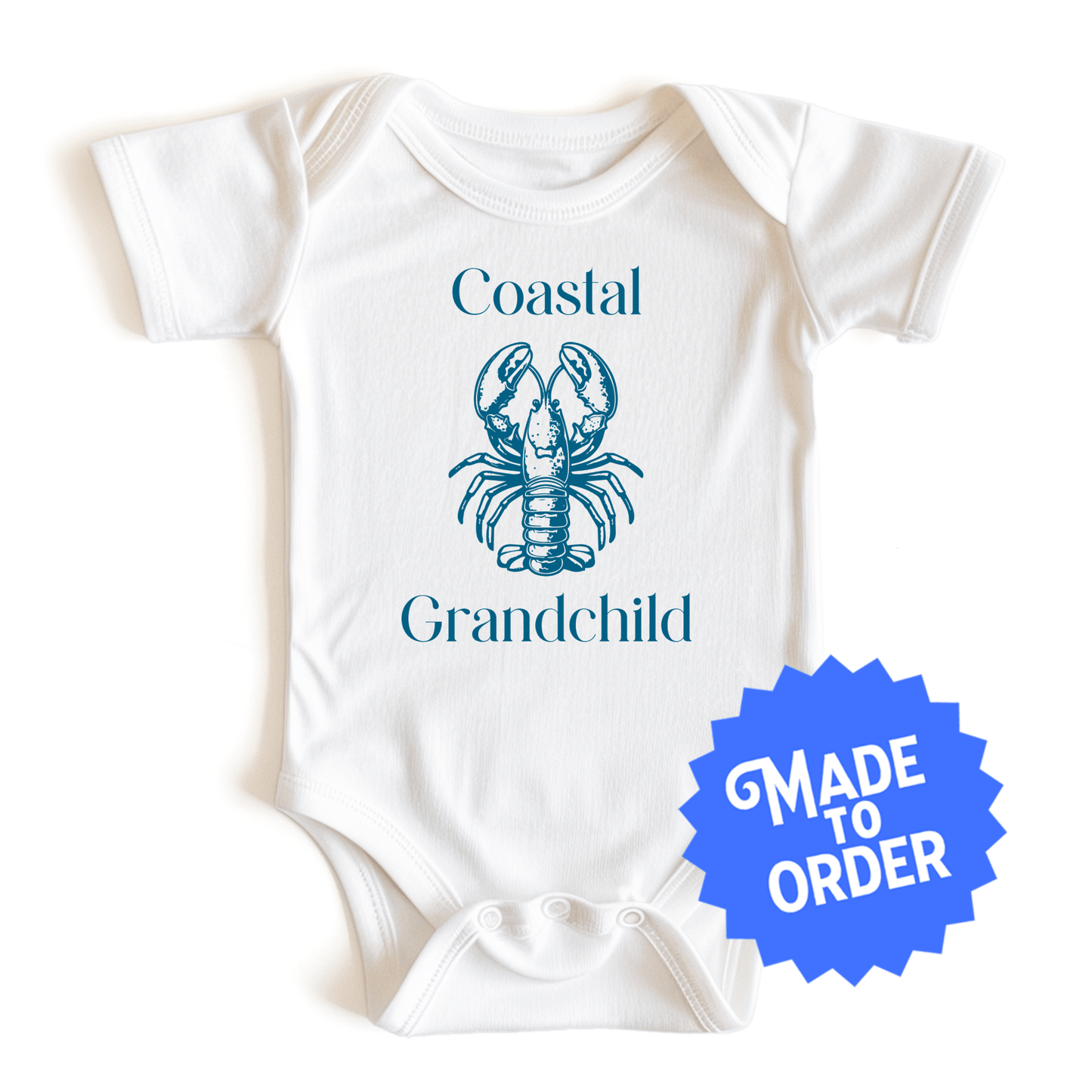 Chunky Deli product image: Natural-colored "Coastal Grandchild" with a lobster icon onesie, 100% cotton with envelope shoulders and three-snap closure, laid flat on a white background.