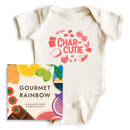 Flat lay of the "Gourmet Baby Starter Pack" including a natural cotton "Char-cutie" baby onesie bodysuit and the "Gourmet Rainbow" board book on a white background. Chunky Deli product display.