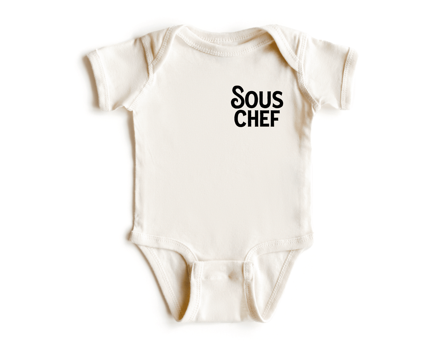 Chunky Deli product image: Natural-colored "Sous Chef" onesie (100% cotton) laid flat on a white background, showcasing the envelope shoulders and three-snap closure.