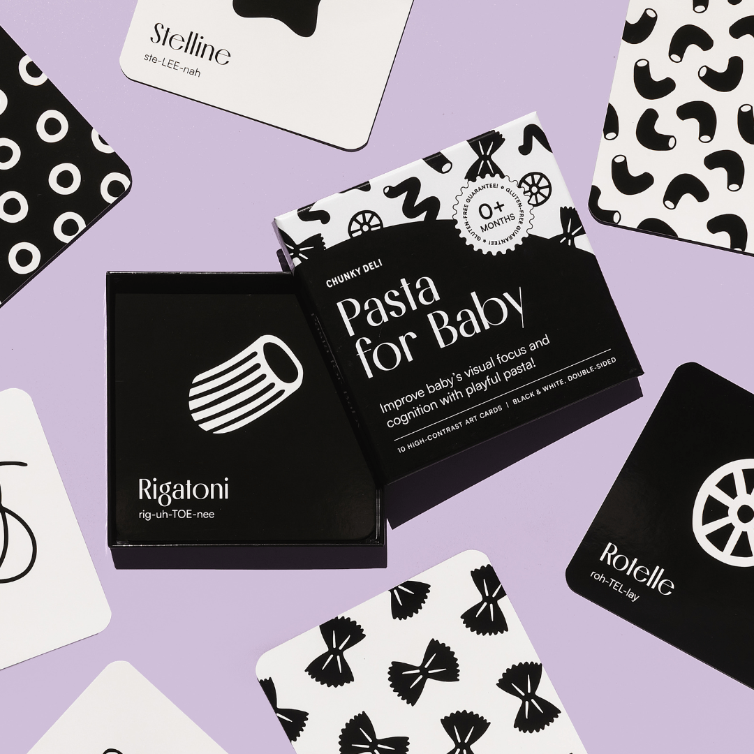 Chunky Deli product image: "Pasta for Baby" black and white art cards box (a visual stimulation and sensory play toy) on a purple background, with several example cards spread around showcasing the high-contrast designs.