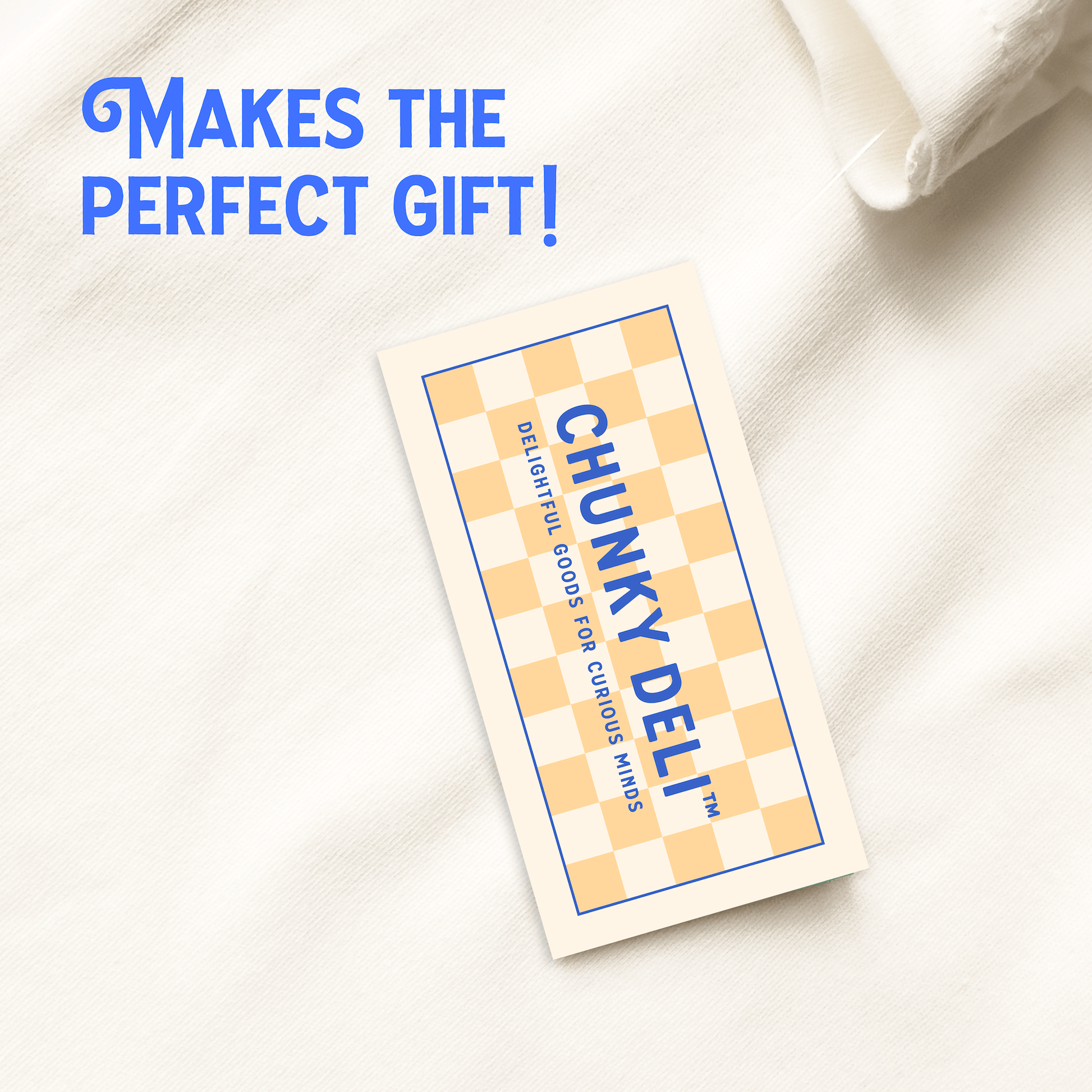 Chunky Deli hang tag attached to apparel, reading "Makes the perfect gift!" and featuring the brand name, trademark, and slogan: "Delightful goods for curious minds." Chunky Deli display photo.