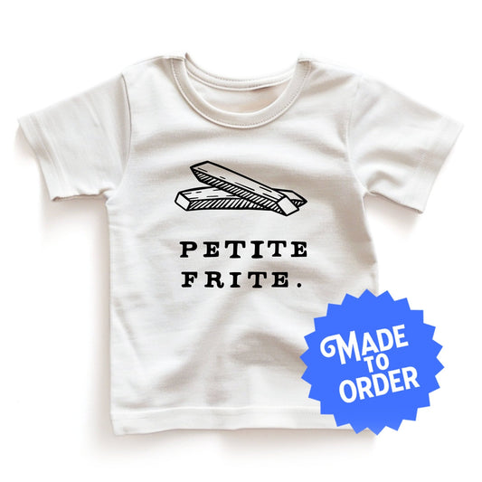 Product display image of the "Petite Frite" kids and toddler t-shirt in natural cotton, laid flat on a white background. Chunky Deli product image.