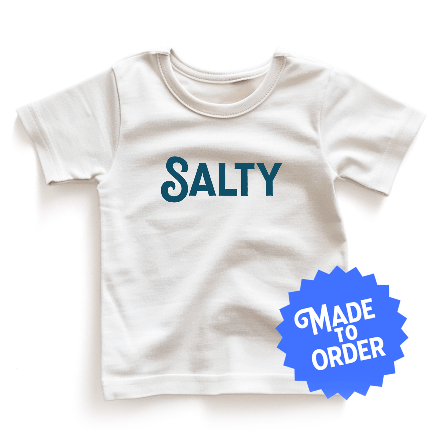 Chunky Deli product image: White short-sleeved kids' and toddler t-shirt with the text "Salty" in cursive font across the chest, laid flat on a white background.