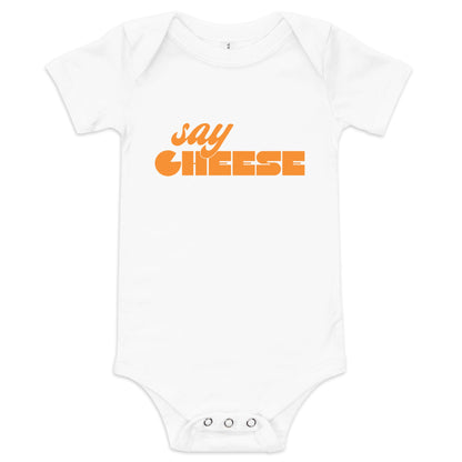 Chunky Deli product image: Natural-colored "Say Cheese" icon onesie, 100% cotton with envelope shoulders and three-snap closure, laid flat on a white background.