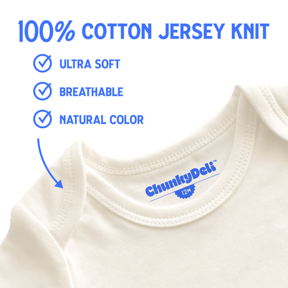 Close-up of a Chunky Deli baby onesie in natural cotton, showing the text "100% Jersey Knit Cotton" with a checkbox next to "Ultra Soft" and "Breathable," with an arrow pointing to the fabric. White background, blue text. Chunky Deli product photo.