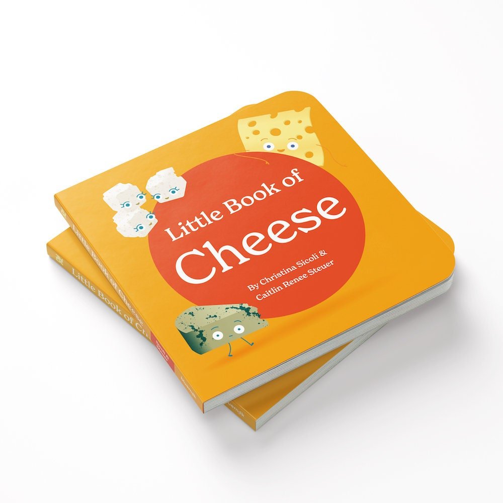 Chunky Deli product image: Stack of two "Little Book of Cheese" books, with the orange cover (red dot, title, author names, and feta, swiss, and gorgonzola illustrations) facing upward, against a white background.